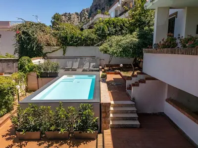 a swimming pool in a yard with plants and stairs at LuminHouse Addaura Pool in Palermo