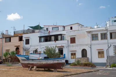 a boat sitting in front of some buildings at Casetta Ciurì in Terrasini
