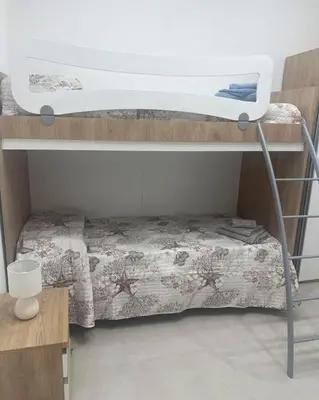 a bedroom with a bunk bed with a bedsheet at Palermo Sunhouse in Palermo