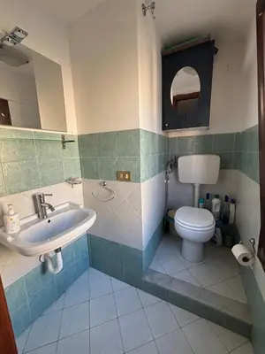 a bathroom with a sink and a toilet at Sumarè in Isola delle Femmine
