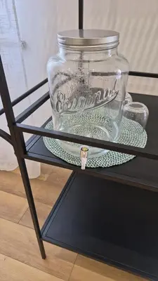 a glass jar sitting on a plate on a table at B&B Magnolie in Palermo