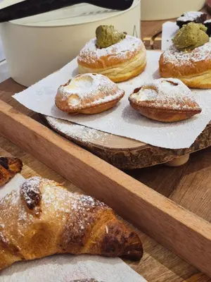 a bunch of pastries sitting on a wooden table at B&B Magnolie in Palermo