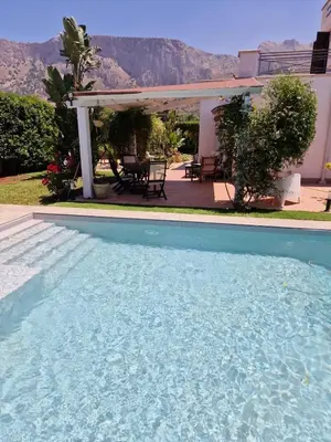 a swimming pool in front of a house at Villa indipendente con piscina in Terrasini