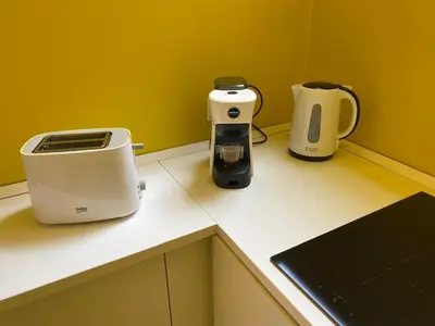 a counter with a toaster and a coffee maker on it at Sunny Apartament in Palermo