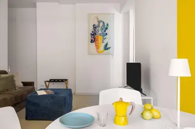 a living room with a table with a yellow vase on it at Sunny Apartament in Palermo