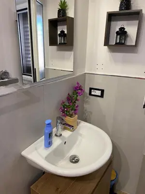 a white sink in a bathroom with a mirror at Le Gemme di Ballarò in Palermo