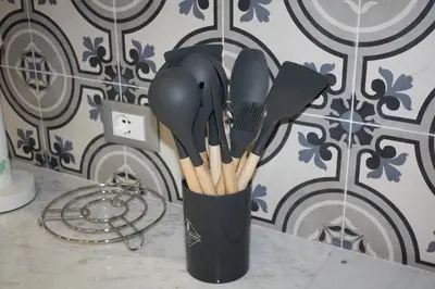 a black cup filled with utensils on a counter at Le Gemme di Ballarò in Palermo