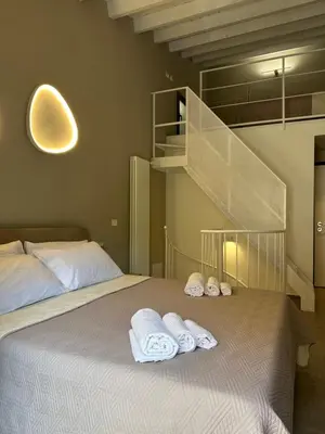a bedroom with a bed with towels on it at House Spa Palermo in Palermo