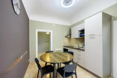 a kitchen and dining room with a table and chairs at Anita House in Palermo