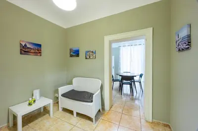 a living room with a chair and a table at Anita House in Palermo