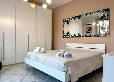 a bedroom with a large bed with towels on it at Sant'Oliva House Palermo in Palermo