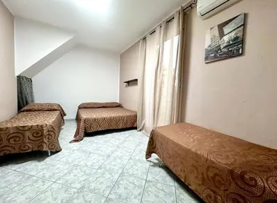 a room with two beds and a window at Sant'Oliva House Palermo in Palermo