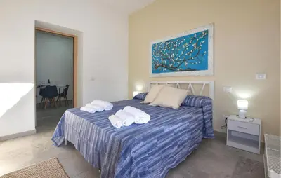 a bedroom with a bed with towels on it at Lovely Home In Isola Delle Femmine With Wifi in Isola delle Femmine
