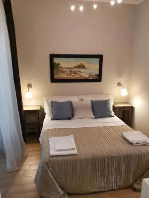 a bedroom with a large bed with two towels on it at B&B Museo Salinas in Palermo