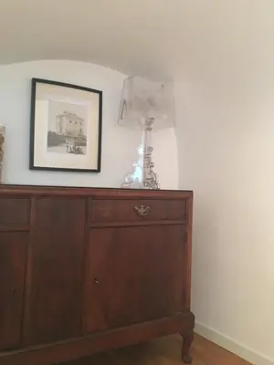 a lamp sitting on top of a wooden dresser at B&B Museo Salinas in Palermo