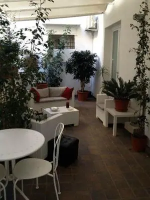 a room with tables and chairs and potted plants at B&B Museo Salinas in Palermo