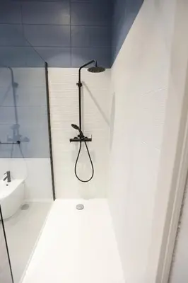 a white bathroom with a shower and a sink at Devalù Politeama - Elegante appartamento al Politeama in Palermo