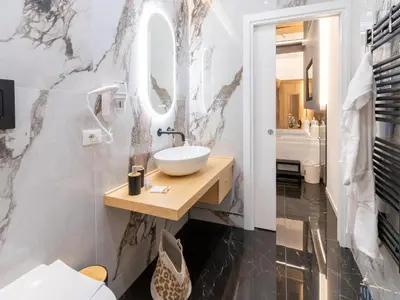 a bathroom with a sink and a mirror at Cupido Apartment in Palermo