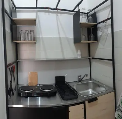 a small kitchen with a sink and a stove at Borgo Vivo in Palermo
