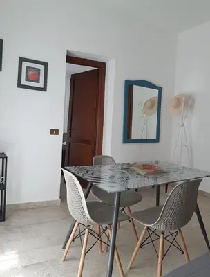 a dining room with a glass table and chairs at Borgo Vivo in Palermo