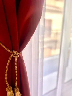 a red curtain in front of a window at Vicolo 25 in Cinisi