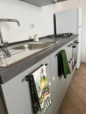 a kitchen with a sink and a counter top at Vicolo 25 in Cinisi