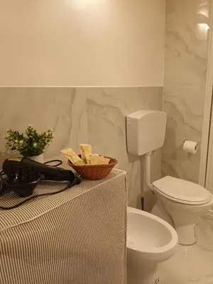 a bathroom with a toilet and a sink at Vicolo 25 in Cinisi