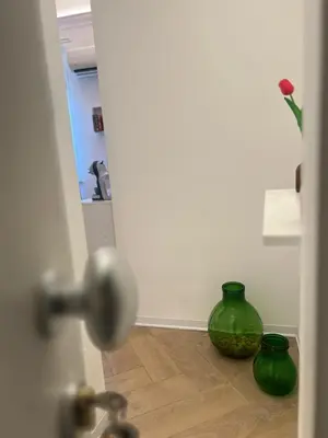 two green vases sitting on the floor in a room at Vicolo 25 in Cinisi