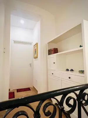 a white room with a white closet and a door at Vicolo 25 in Cinisi