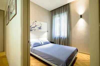 a small bedroom with a bed and a window at Exclusuite Design Apartment in Palermo