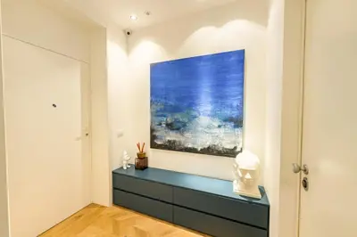 a living room with a painting on the wall at Exclusuite Design Apartment in Palermo