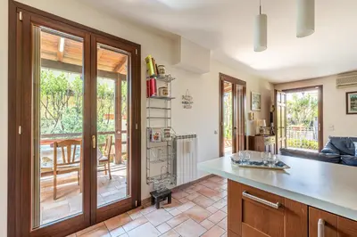 a kitchen with a counter and an open door to a patio at Antonio Family House a Mondello by Wonderful Italy in Palermo