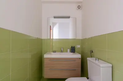 a bathroom with a white sink and a toilet at Antonio Family House a Mondello by Wonderful Italy in Palermo