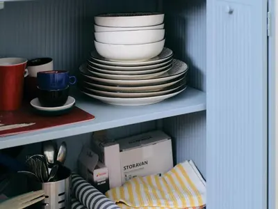 a stack of plates and bowls on a shelf at La casa di giù in Palermo
