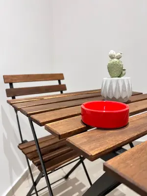 a wooden table with a red bowl on top of it at Moonlight Rooms in Termini Imerese