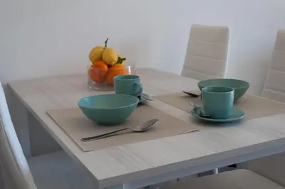 a table with three bowls and cups on it at Nuovo appartamento sul mare immerso nel verde in Palermo
