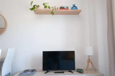 a flat screen tv sitting on top of a table at Nuovo appartamento sul mare immerso nel verde in Palermo