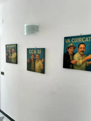 four posters on a wall on a white wall at MondHello a 2 passi dal mare in Palermo