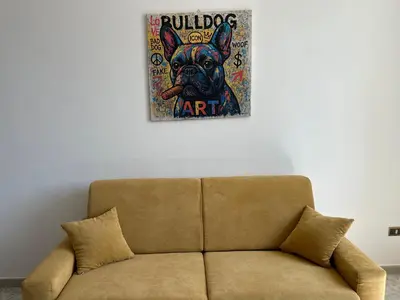 a couch in a living room with a picture of a dog at MondHello a 2 passi dal mare in Palermo
