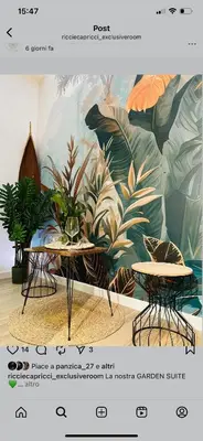 two tables in front of a mural of plants at Ricci & Capricci Exclusive Room in Aspra