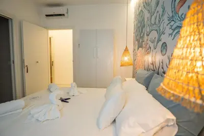 a bedroom with a bed with stuffed animals on it at Ricci & Capricci Exclusive Room in Aspra