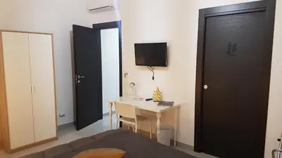 a small room with a desk and a black door at Buonaluna B&B in Palermo