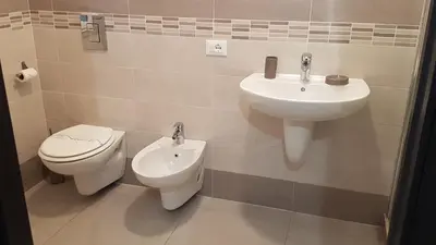 a bathroom with a toilet and a sink at Buonaluna B&B in Palermo