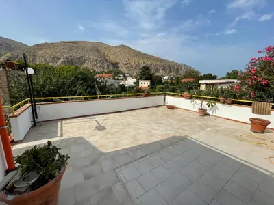 a balcony with a view of a mountain at Alta Marea Mondello - Palermo in Palermo