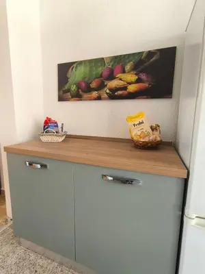 a kitchen counter with a painting of fruit on the wall at Azzurra Apartment Mondello - Casa Vacanza a due passi dal Mare in Palermo
