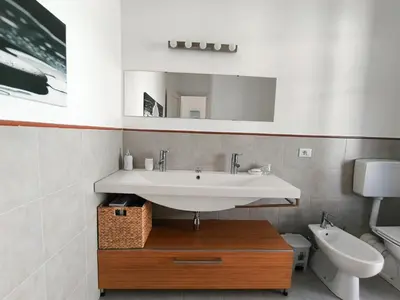 a bathroom with a sink and a toilet at Azzurra Apartment Mondello - Casa Vacanza a due passi dal Mare in Palermo
