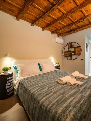 a bedroom with a large bed with two towels on it at Meschita Sette in Palermo