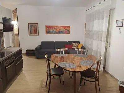 a living room with a table and a couch at House Dotto 25 Apartment in Palermo