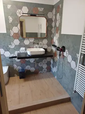 a bathroom with a sink and a mirror on a wall at House Dotto 25 Apartment in Palermo