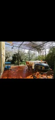 a patio with a table and a blue bench at Casa Pizzillo in Campofelice di Roccella